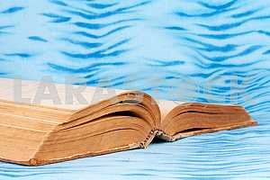 Old and used hardback books or text books on wooden table. Books and reading are essential for self improvement, gaining knowledge and success in our careers, business and personal lives. Copy space