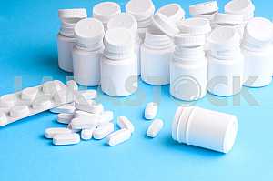Many pills and tablets isolated on light blue background