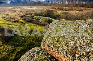 The exit to the surface of the massive blocks of lower Proterozoic granites, covered with moss