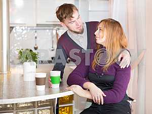 Young happy couple drinking tea in the morning