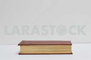 Stack of hardback books on blue cloth. Back to school. Copy space