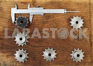 Different construction tools on a wooden background - screwdriver, caliper.