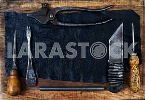 Different construction tools on a wooden background - screwdriver, caliper.