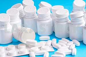 Many pills and tablets isolated on light blue background