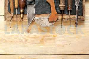 Carpenter tools on wooden table with sawdust. Circular Saw.