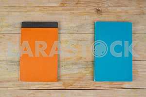 Open book, stack of hardback books on wooden table. Back to school. Copy space