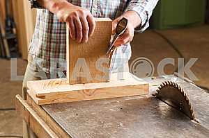 Carpenter tools on wooden table with sawdust. Circular Saw. Carpenter workplace top view