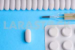 Many pills and tablets isolated on light blue background
