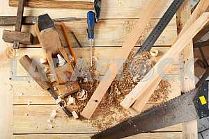 Carpenter tools on wooden table with sawdust. Circular Saw.