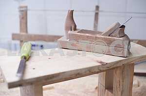 Different construction tools on a wooden background - screwdriver, caliper.