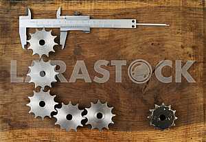 Different construction tools on a wooden background - screwdriver, caliper.