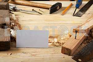 Carpenter tools on wooden table with sawdust. Circular Saw.