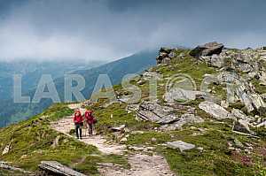 Two tourists with backpacks, go mountain ridge Chornohora