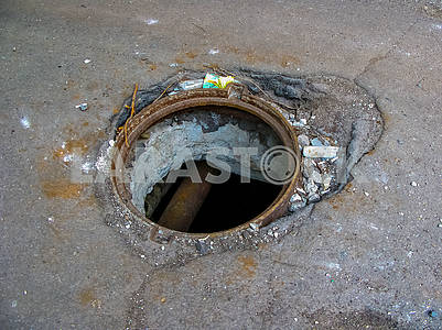 Open sewer manhole on the road