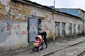A woman carries a carriage