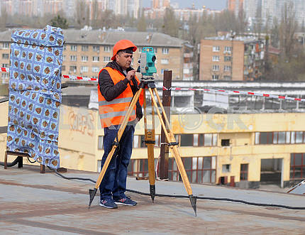 Worker with a theodolite