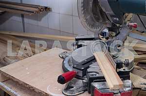 Different construction tools on a wooden background - screwdriver, caliper.