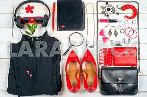 Women clothing set and accessories on white wooden background.