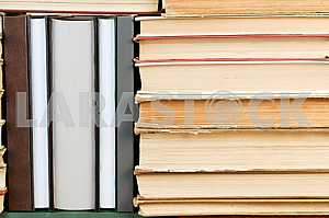 Open book, stack of hardback books on wooden table. Back to school. Copy space