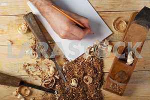 Carpenter tools on wooden table with sawdust. Circular Saw.