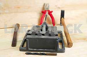 Different construction tools on a wooden background - screwdriver, caliper.