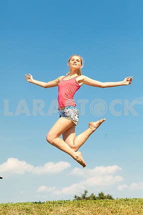 Happy young women jumping in field