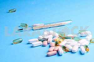 Many pills and tablets isolated on light blue background