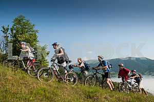 Tourists with backpacks on the bike in the Carpathian Mountains