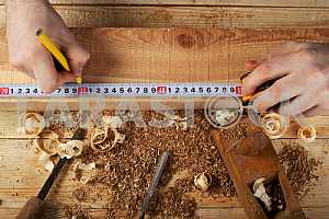 Carpenter tools on wooden table with sawdust. Circular Saw.