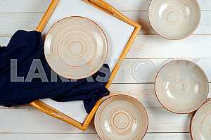 Blank white dish on a wood background.