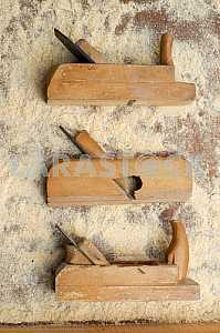 Different construction tools on a wooden background - screwdriver, caliper.