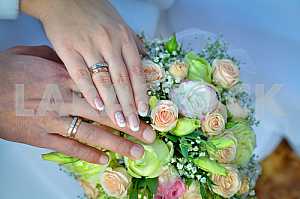 Wedding Bouquet with hands on it, rings