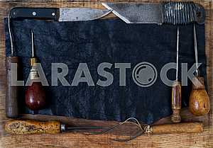 Different construction tools on a wooden background - screwdriver, caliper.