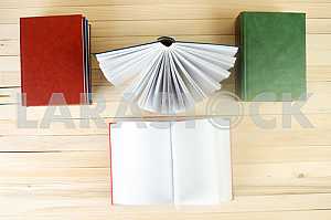 Stack of hardback books on wooden table. Back to school. Copy space