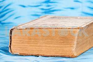 Old and used hardback books or text books on wooden table. Books and reading are essential for self improvement, gaining knowledge and success in our careers, business and personal lives. Copy space