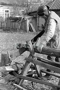 The man is sawing firewood