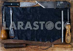 Different construction tools on a wooden background - screwdriver, caliper.