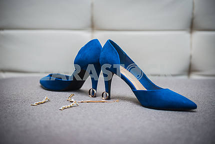 beautiful bride shoes with a gorgeous earrings on the sofa girl in shoes with high heels pair of blue shoes with heels shoes