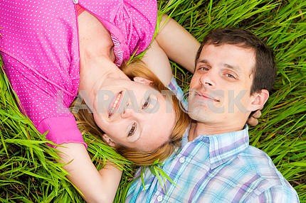 Young love Couple lie on grass