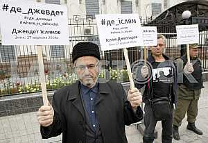 Activists hold placards
