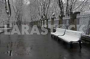 Snow-covered benches in the park
