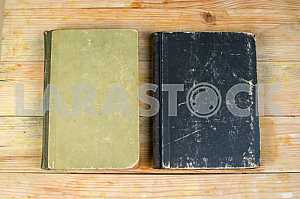 Open book, stack of hardback books on wooden table. Back to school. Copy space
