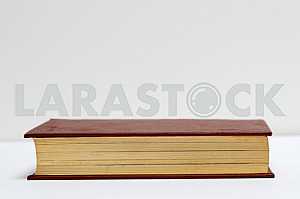 Stack of hardback books on blue cloth. Back to school. Copy space