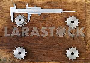 Different construction tools on a wooden background - screwdriver, caliper.
