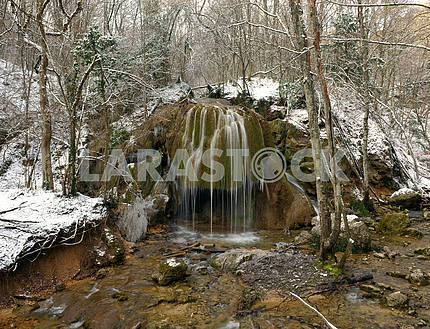 Falls in the winter forest