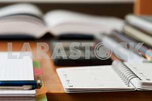 Stack of hardback books on wooden table. Back to school. Copy space. Top view