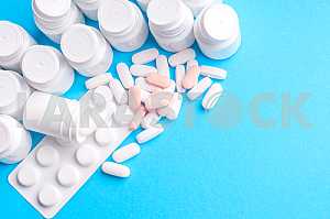Many pills and tablets isolated on light blue background