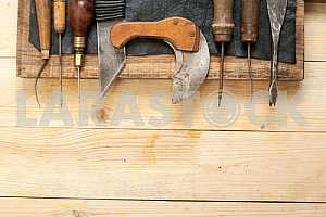 Carpenter tools on wooden table with sawdust. Circular Saw.