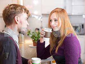 Young happy couple drinking tea in the morning