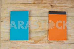 Open book, stack of hardback books on wooden table. Back to school. Copy space